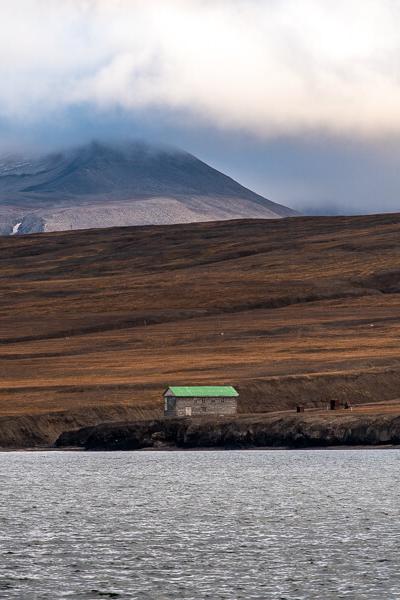 Svalbard Seaview Shore House Green Roof Mountains Clouds900