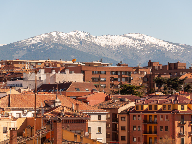 ES_Segovia_tiled_rooftops_snowy_mountain